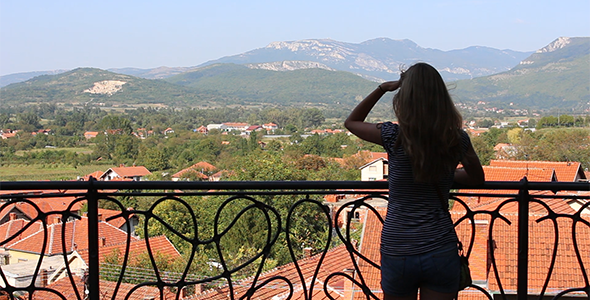 Girl Looking Far Away from the Balcony