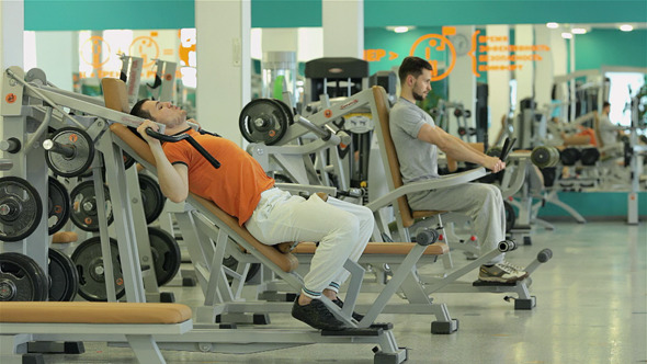 Two Men Doing Exercise For The Chest Muscles alt