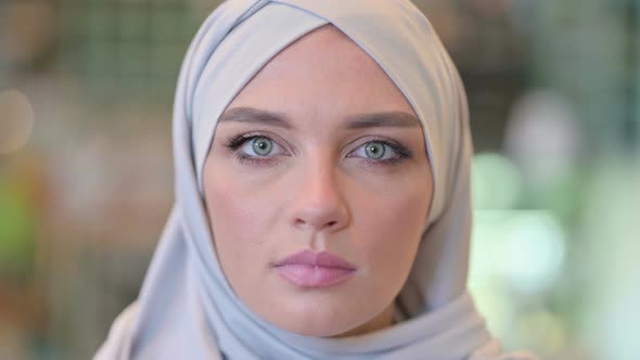 Portrait of Face of Serious Young Arab Woman with Hijab Looking at the Camera 