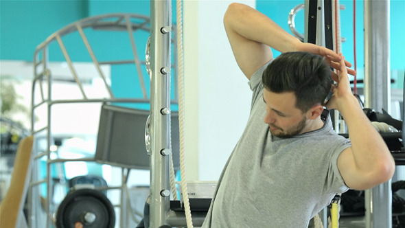 Young Man Doing Exercise With Barbell alt