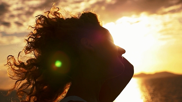 Happy and Free Woman at Sunset