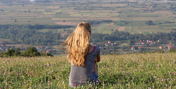 Girl Sitting on Top of the Hill Looking Far Away 2