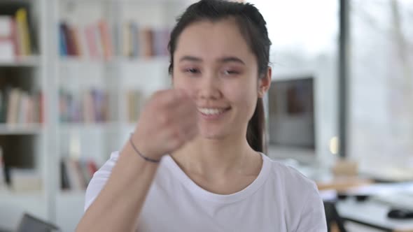 Portrait of Young Asian Woman Pointing with Finger 