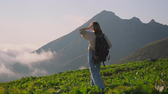 Inspired Teen Girl is Exploring Mount Walking on Top Above Clouds