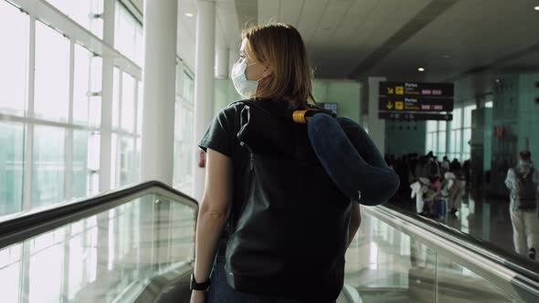 Young Woman in Medical Mask with Backpack in Terminal Airport