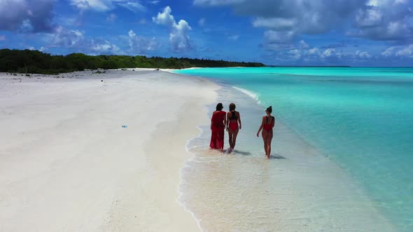 Sexy fun women travelling in the sun at the beach on summer white sandy and blue 4K background