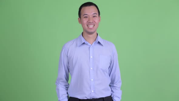 Studio Shot of Happy Asian Businessman Smiling