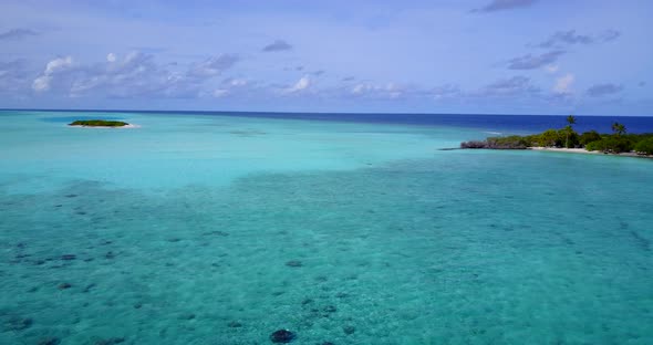 Daytime aerial clean view of a white paradise beach and aqua blue ocean background 