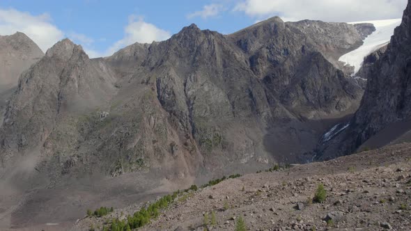 High mountains of Aktru valley with ice and forest