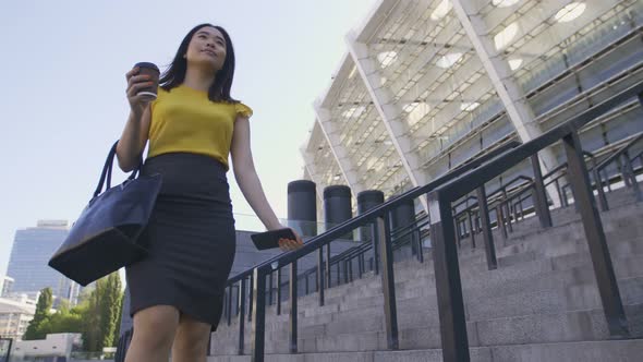 Asian Office Worker with Coffee on the Way To Work