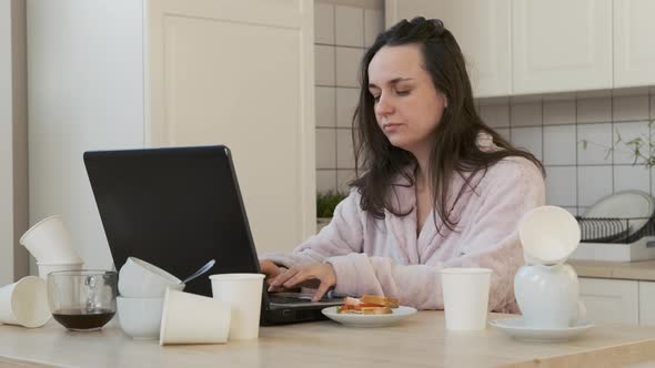 Exhausted Woman Drinks Coffee While Works at Home