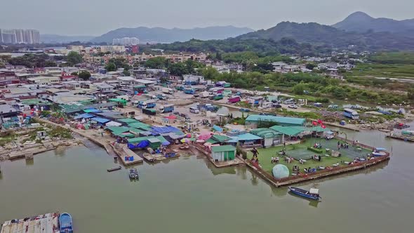 A dynamic orbiting aerial footage of a seafood restaurant in the fishing village in Lau Fau Shan in