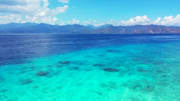 Aerial drone shot travel of beautiful coastline beach wildlife by shallow sea with white sandy backg