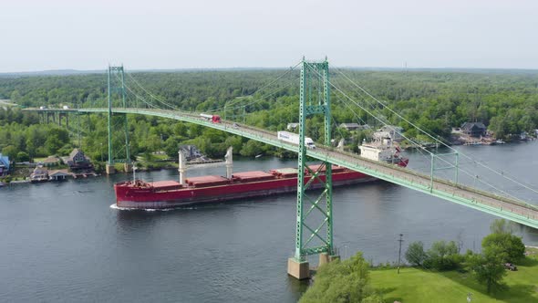 Tanker Ship Passes Under the Thousand Islands Bridge in Alexandria Bay, New York - Aerial Drone View