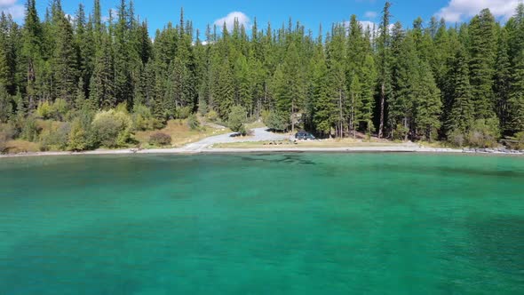 Lush Green Forest And Still Blue Green Water Of Lake Ashley in Montana On A Beautiful Day - aerial s