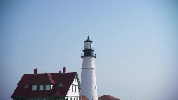 Iconic Maine lighthouse. Zooms out to reveal flowers.