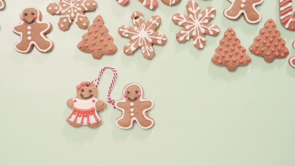 Traditional home made gingerbread cookies as food gifts on blue background with Christmas light.