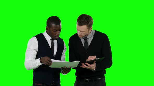 Businessman Considering Documentation. Green Screen