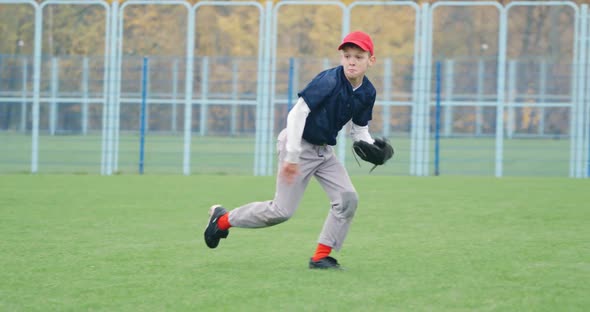 Baseball Tournament at School the Boy Pitcher Catches a Fastball in the Glove and Sends a Pass To