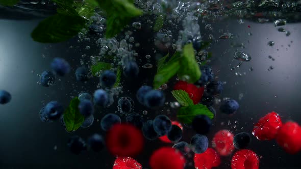 Ripe bright wild berries raspberries, blueberries and mint are submerged. Berry Fresh Iced Tea