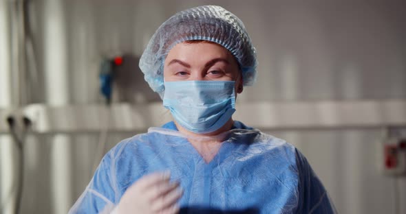 Portrait of Happy Woman Surgeon Removing Safety Mask and Smiling at Camera