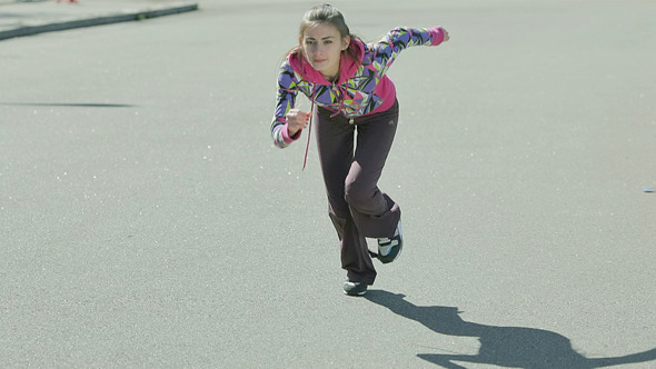 Young Girl Doing a Race at the Stadium