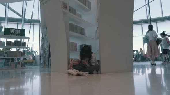 Chinese Girl Sitting On The Floor And Reading A Book In The Shanghai Bookstore 4 K