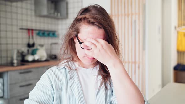 Sad Young Woman Sitting at Home