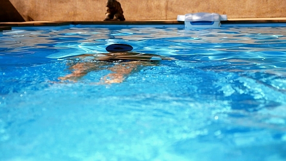 Man Swimming under Water in Slow Motion