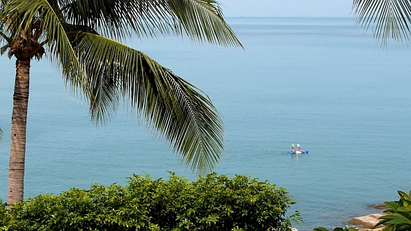 Travelers Kayaking in the Sea