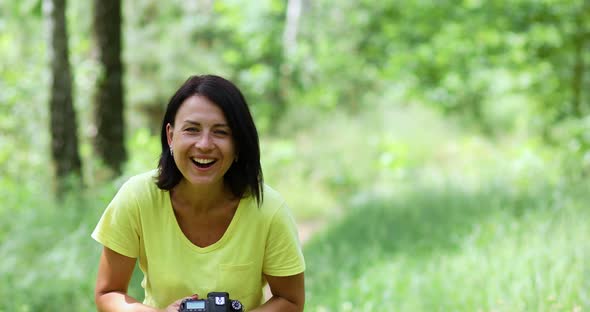 Female Photographer Take Photo with a Professional Camera Outdoor