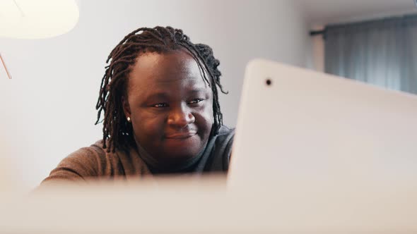 Young African Man Smiling and Nodding the Head While Having Video Call