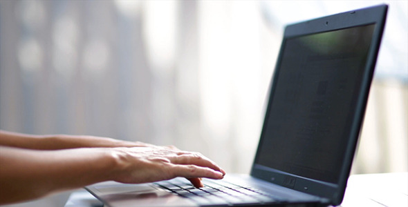 Female Hands Write on the Keyboard