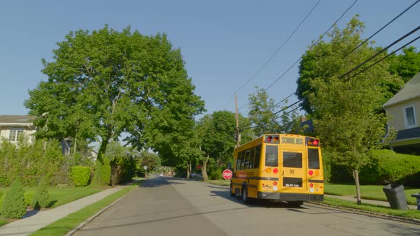 Yellow School Bus Stopped In front of Suburban Neighborhood in Roslyn