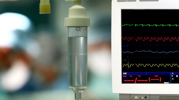 Surgeons With ECG Monitor