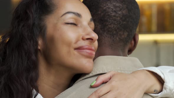 Woman in Love Hugs Partner Tightly with Closed Eyes Smiling