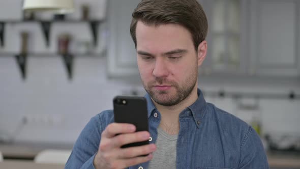 Portrait of Beard Young Man Using Smartphone