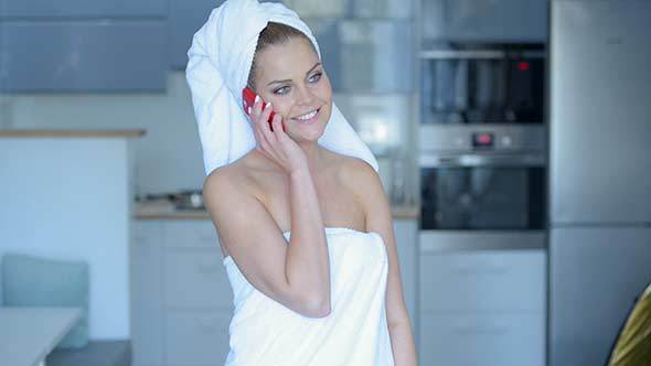 Woman in Bath Towel Talking on Cell Phone