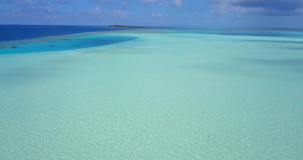 Wide angle overhead copy space shot of a sunshine white sandy paradise beach and blue sea background