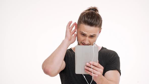 Portrait of Young Handsome Man Speaking on Tablet