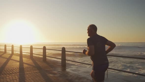 Senior man running on the promenade