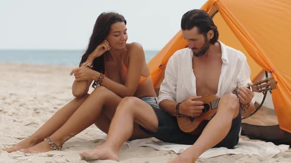 Romantic Couple Near a Tent on the Beach