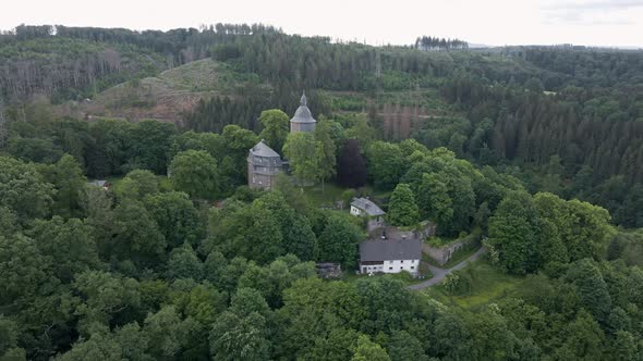 circular drone shot of Wildenburg Castle in the southeast of the village of Friesenhagen, in the Nor