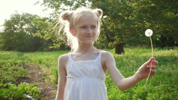 Child Girl Playing With The Dandelion Flower 