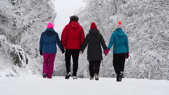 Family Walking in Winter Forest