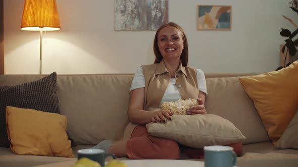 Cheerful Woman Watching Comedy at Home and Laughing