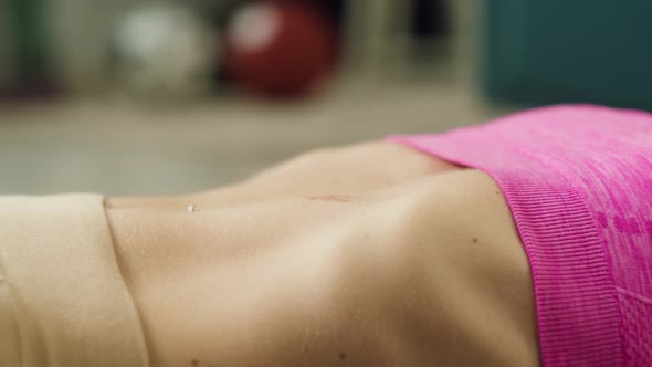 Sportswoman Pumping Press on Mat Muscles Closeup