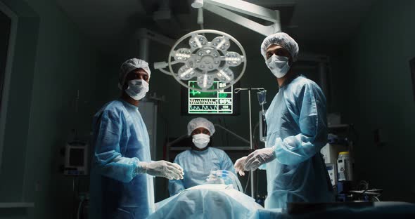 A Team of Surgeons Perform an Operation in a Bright Operating Room