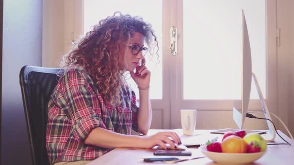 Young woman working at home or in a small office