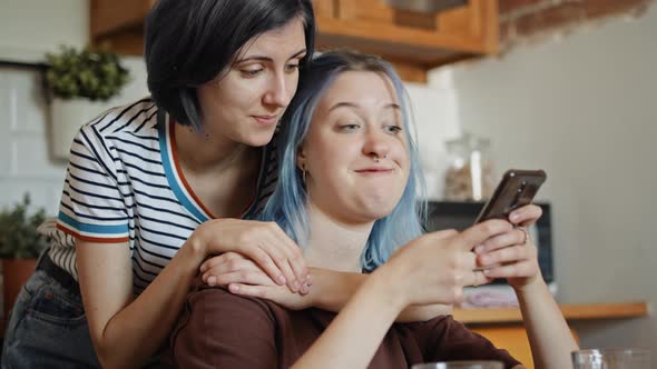 Handheld video of women browsing something on the phone, Shot with RED helium camera in 8K